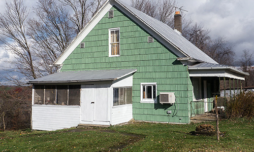 Exterior of green farm house